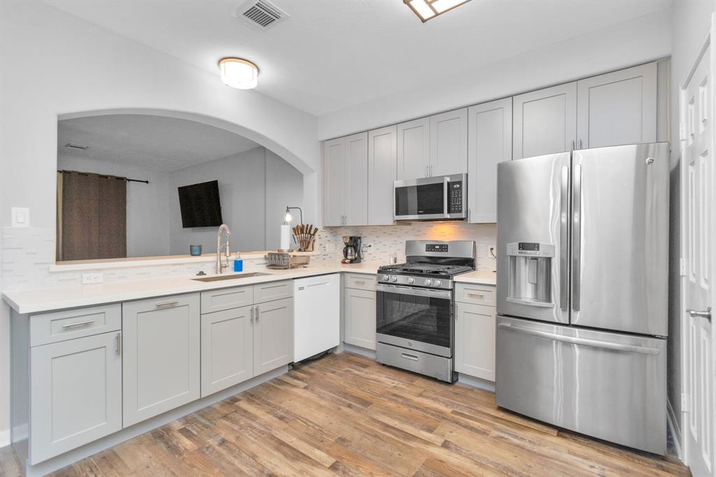 a kitchen with a refrigerator stove and sink