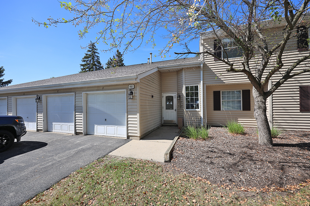 a view of a house with a yard and garage