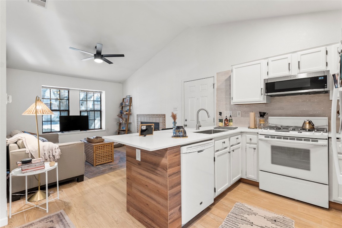 a kitchen with a sink a stove and cabinets