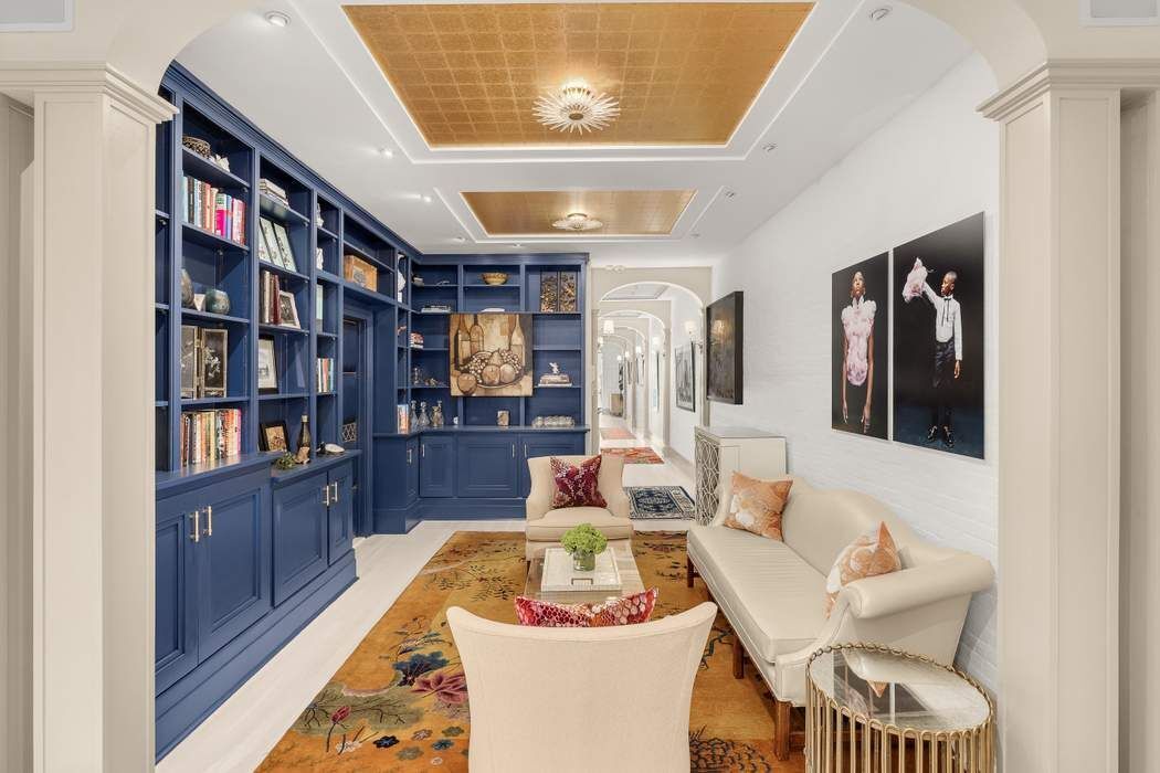 a living room with furniture and a book shelf