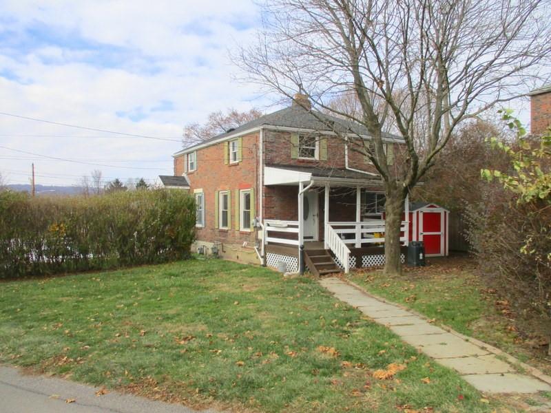 a view of a house with a yard and sitting area