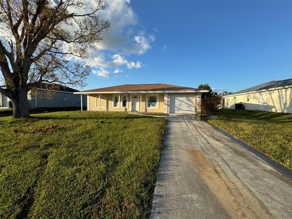 a view of house with yard