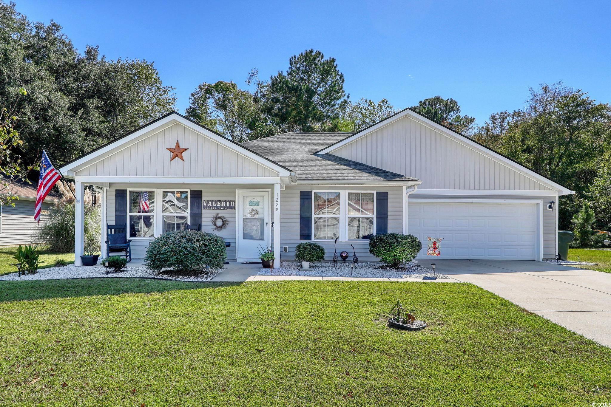 Ranch-style house with a front yard and a garage