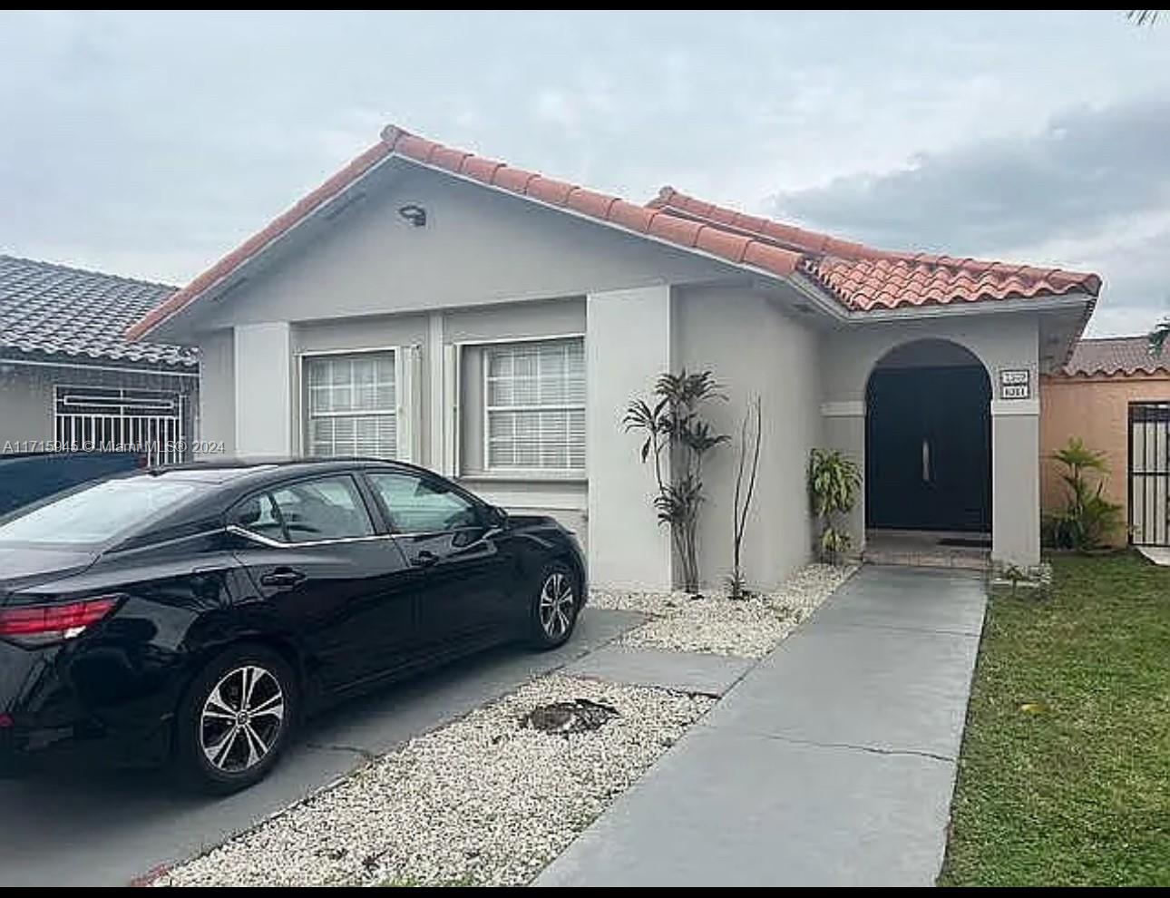 a front view of a house with parking space