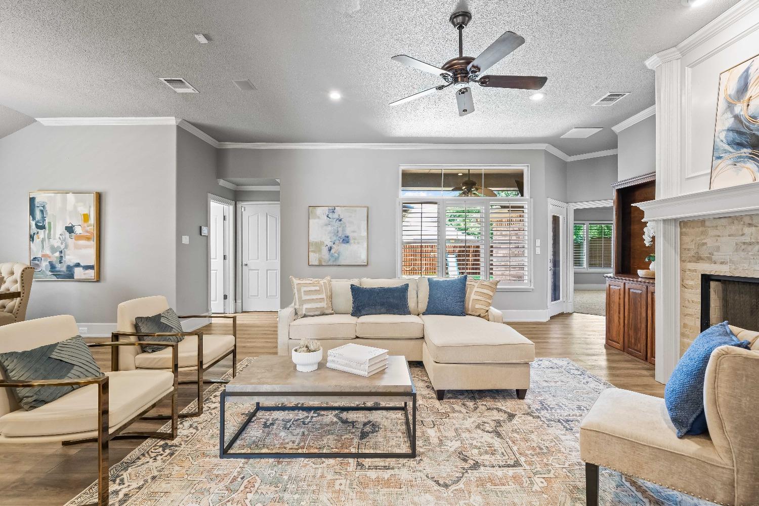 a living room with furniture a fireplace and a chandelier