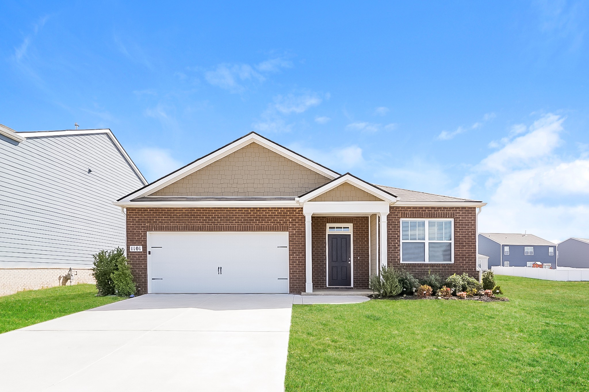 a front view of a house with a yard and garage