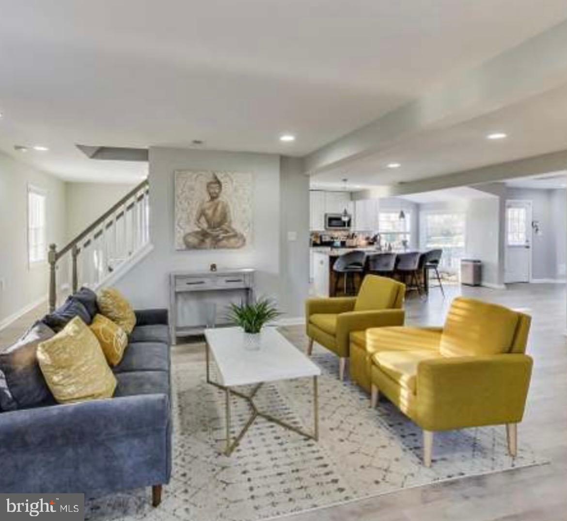 a living room with furniture kitchen view and a table