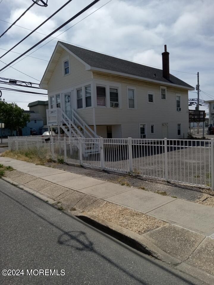 a front view of a house with a fence