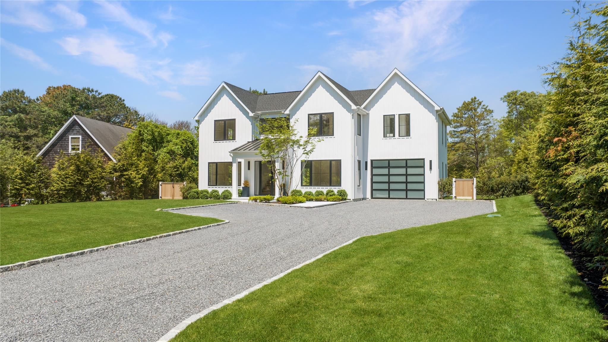 View of front of property with a front lawn and a garage