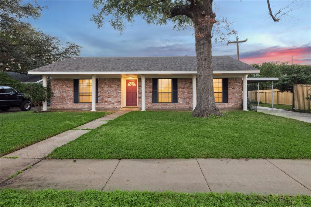 a front view of a house with a garden and yard