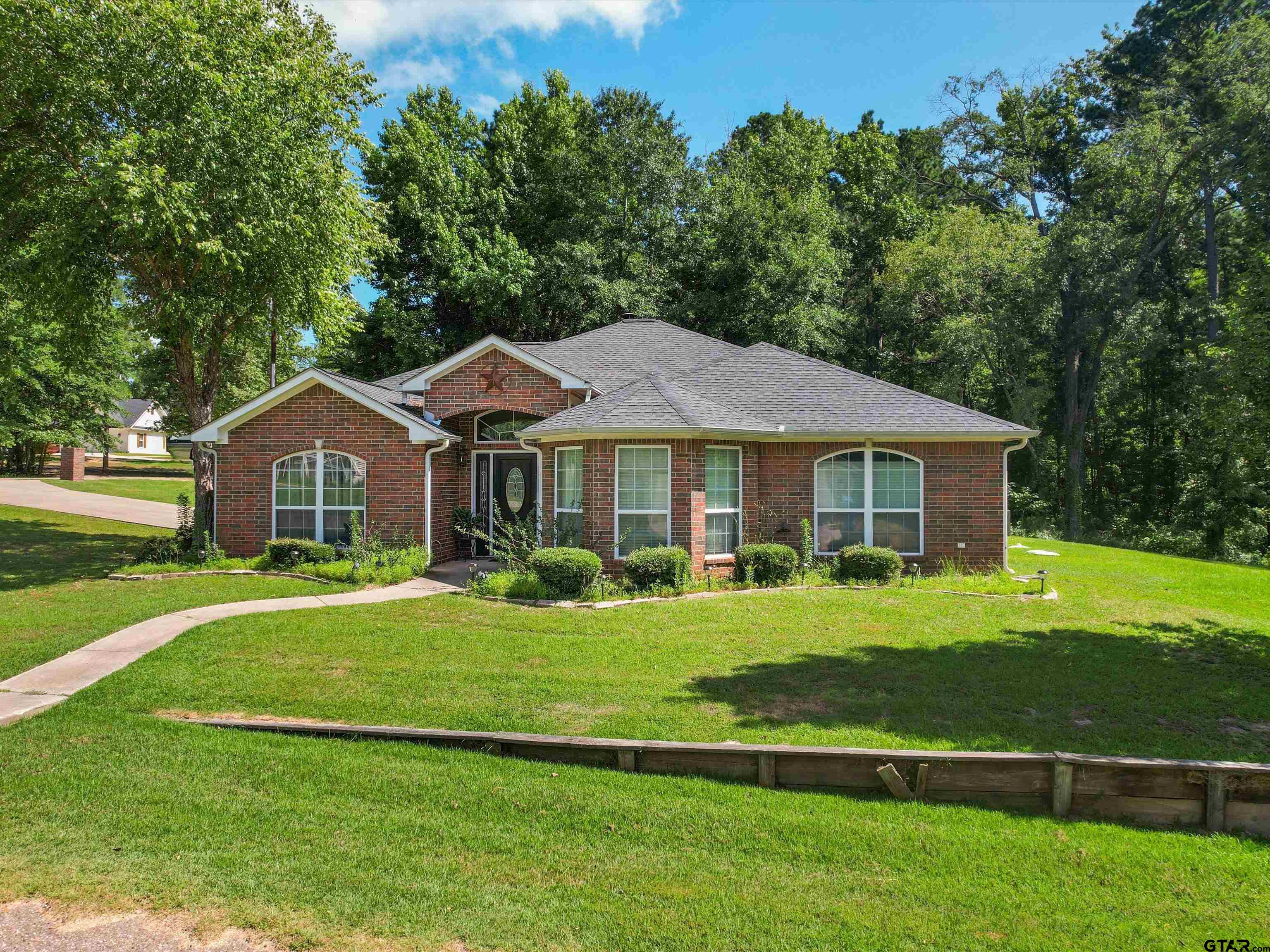 a front view of a house with a yard