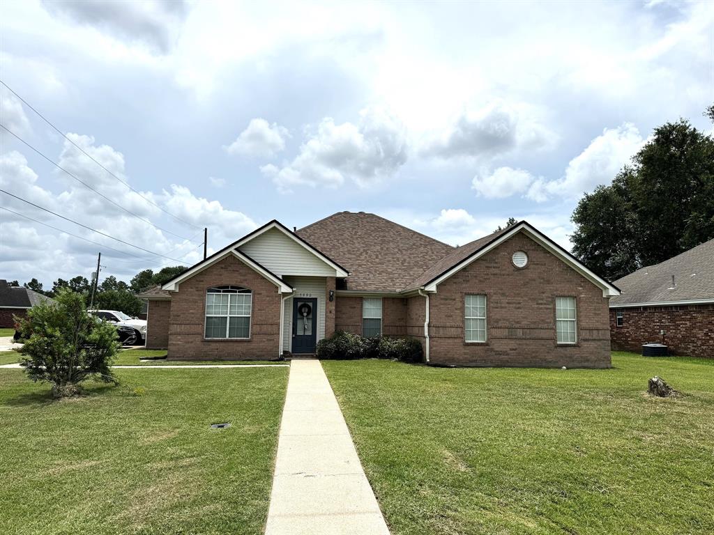 a front view of a house with a garden