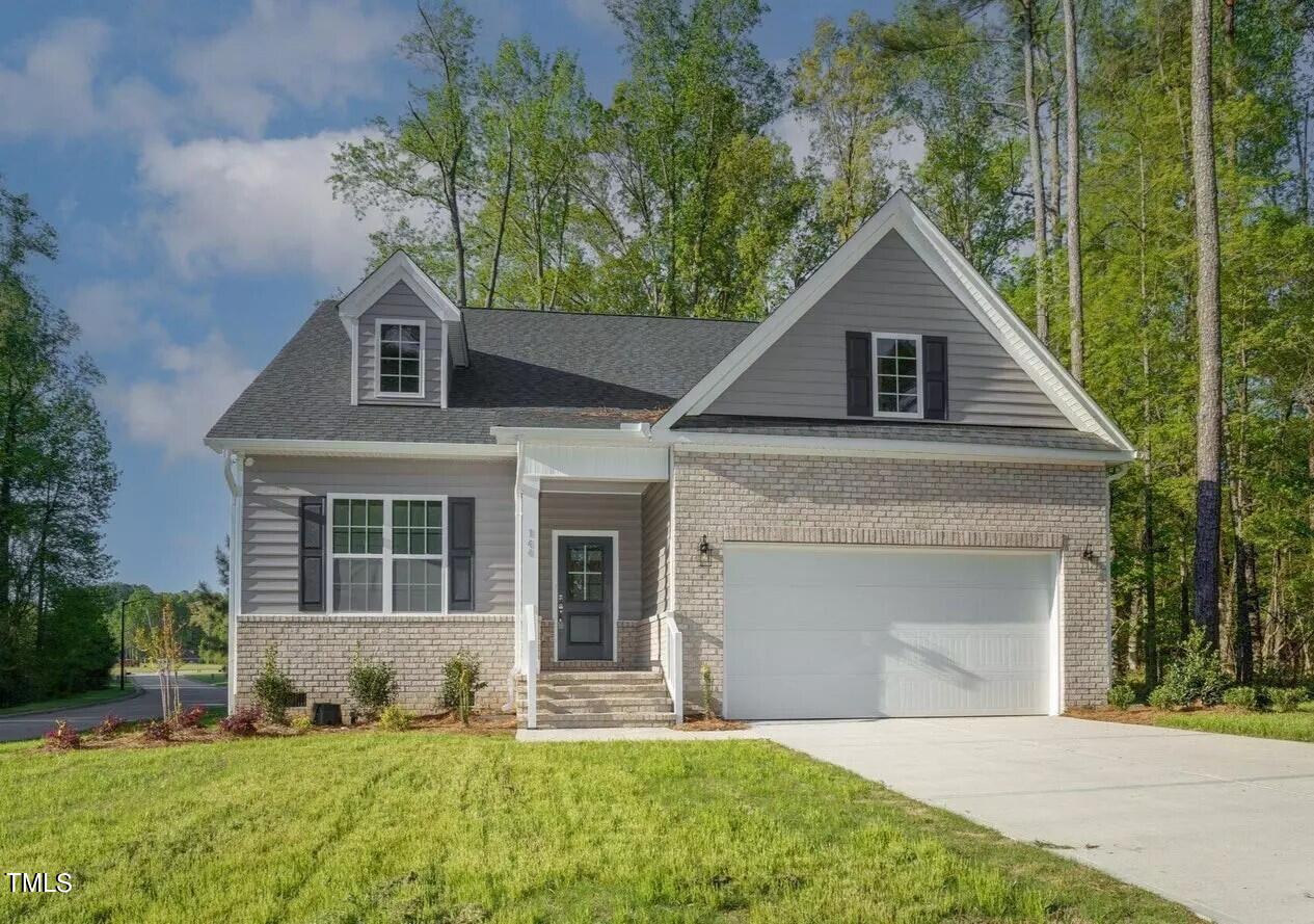 a front view of a house with a yard and garage