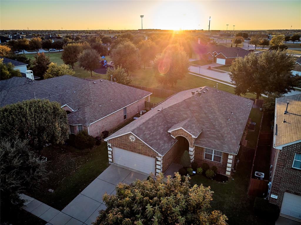 an aerial view of houses with a yard