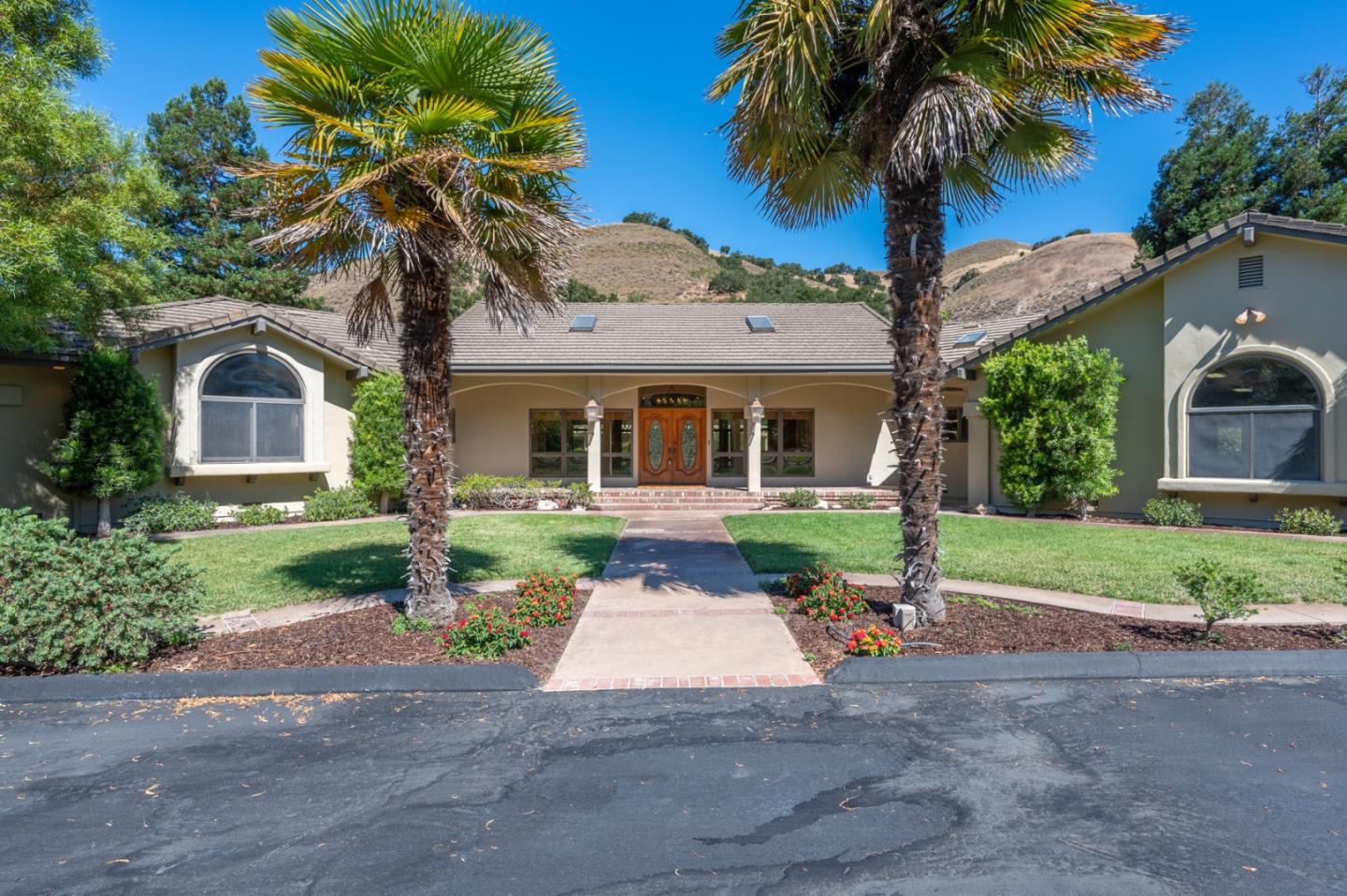 a front view of a house with a garden and yard