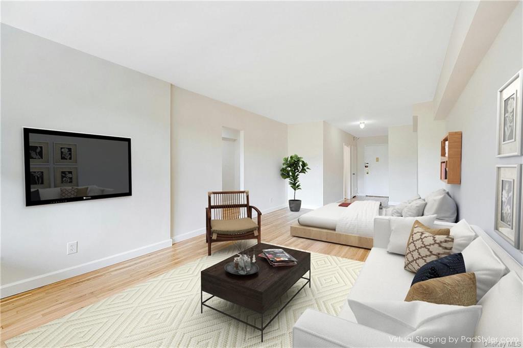 My Virtually Staged photo of similar unit Living room with hardwood / wood-style flooring