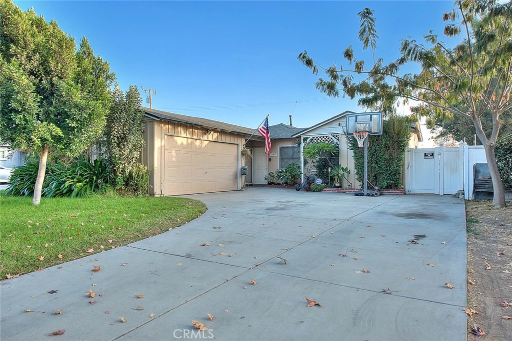 a view of a house with a tree and a yard