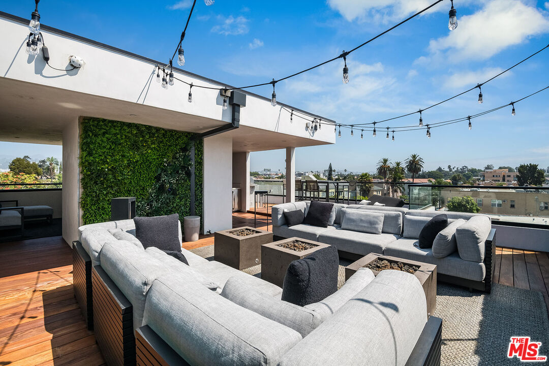 a living room with patio furniture and a floor to ceiling window