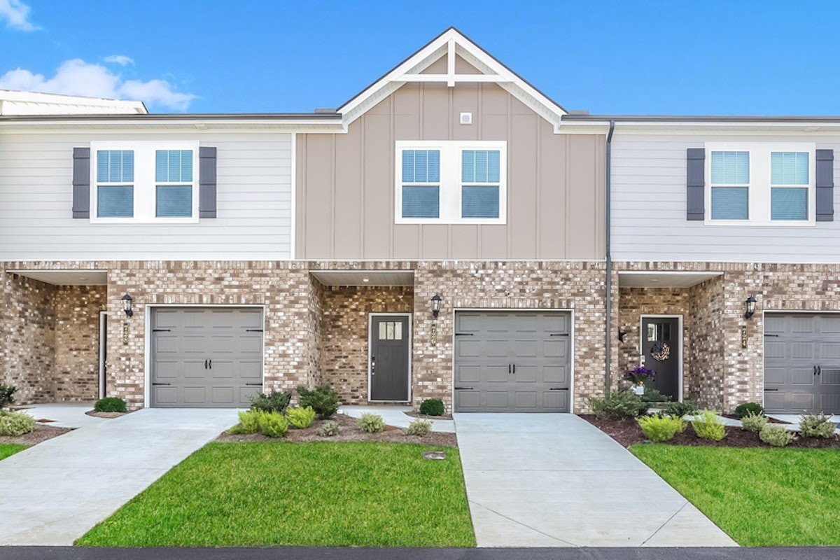 a front view of a house with a yard and garage