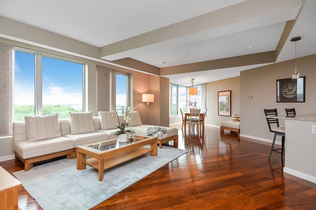 a living room with fireplace furniture and a large window