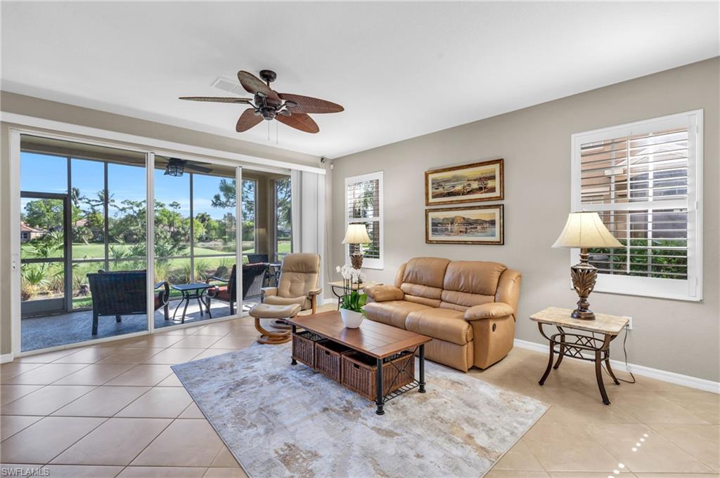 Tiled living room featuring ceiling fan