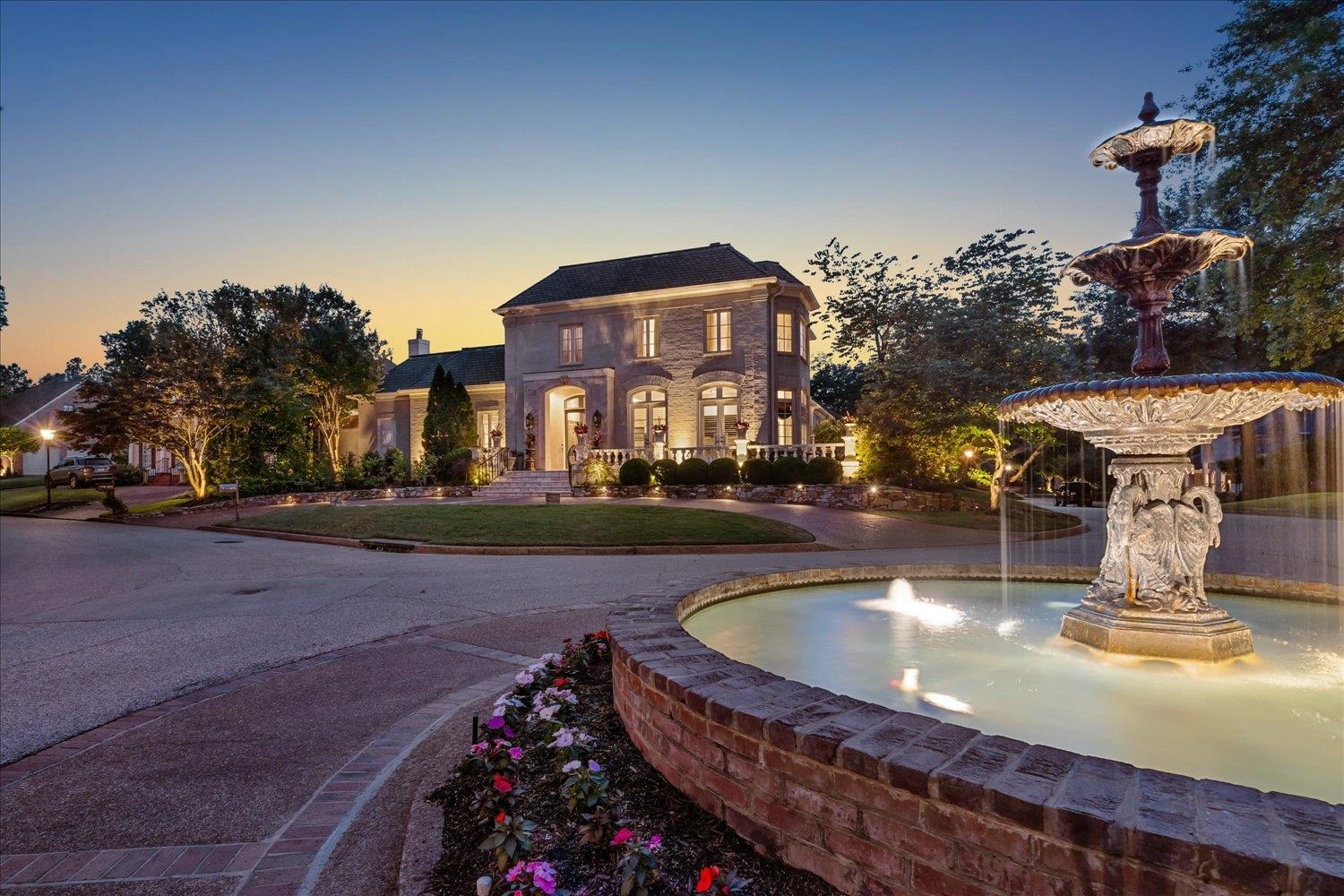 a view of a water fountain in front of the house