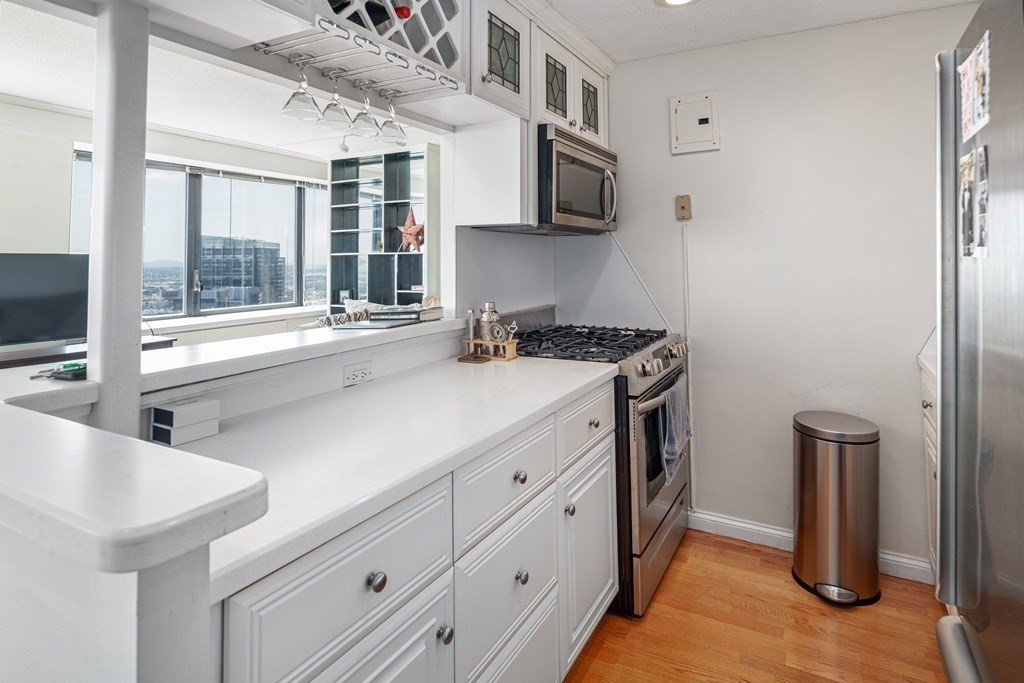 a kitchen with stainless steel appliances granite countertop a sink and a stove