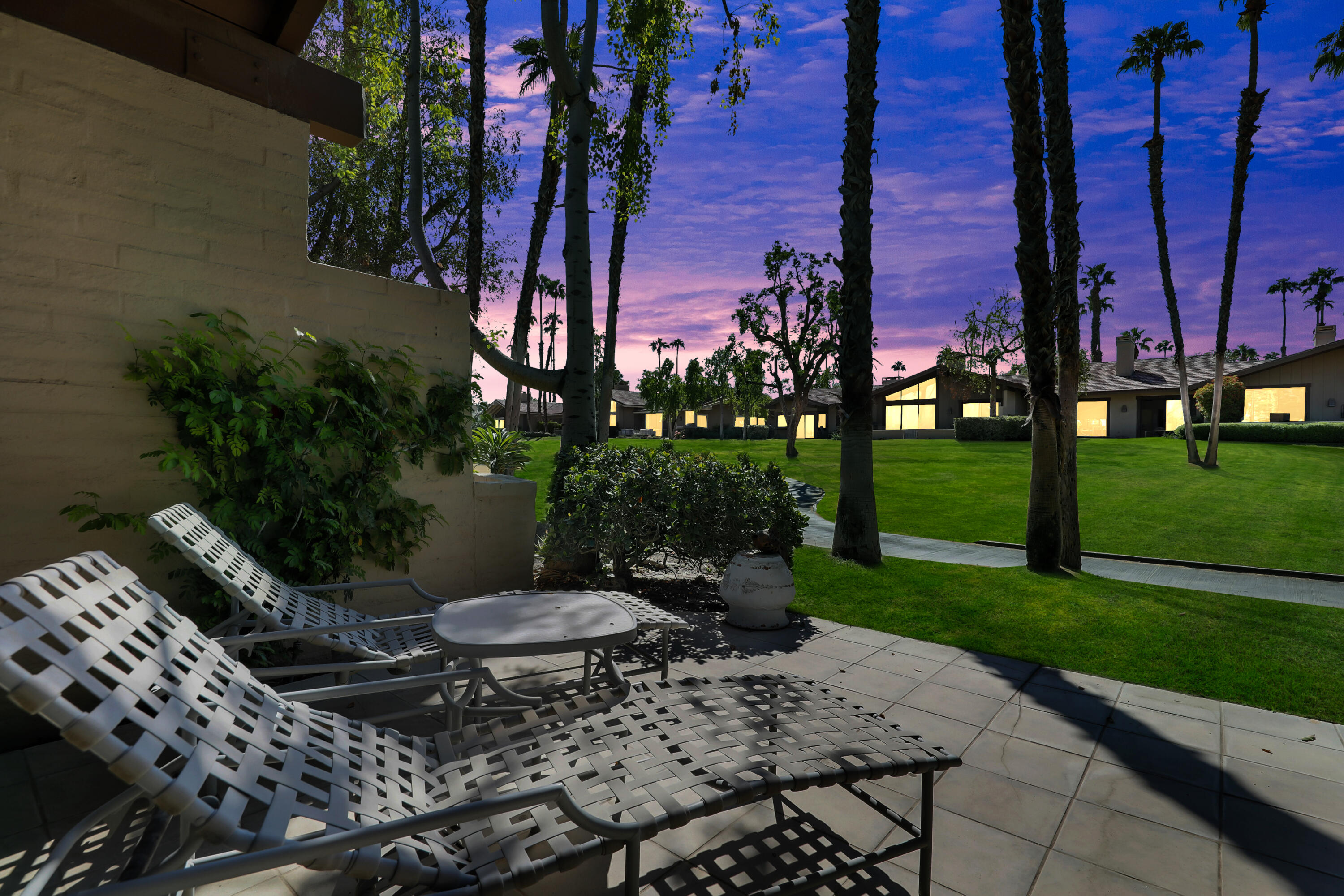 a view of a chairs and table in backyard