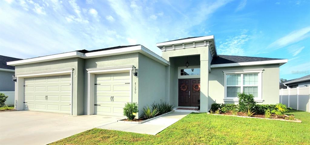 a front view of a house with a yard