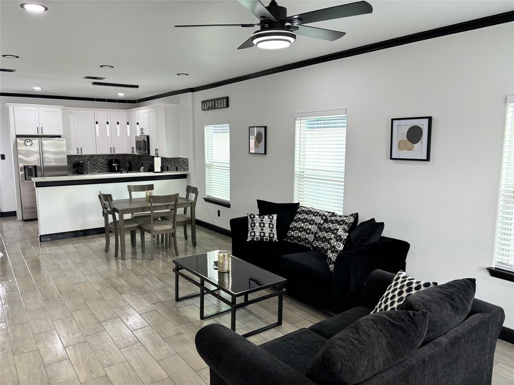 a living room with furniture and kitchen view