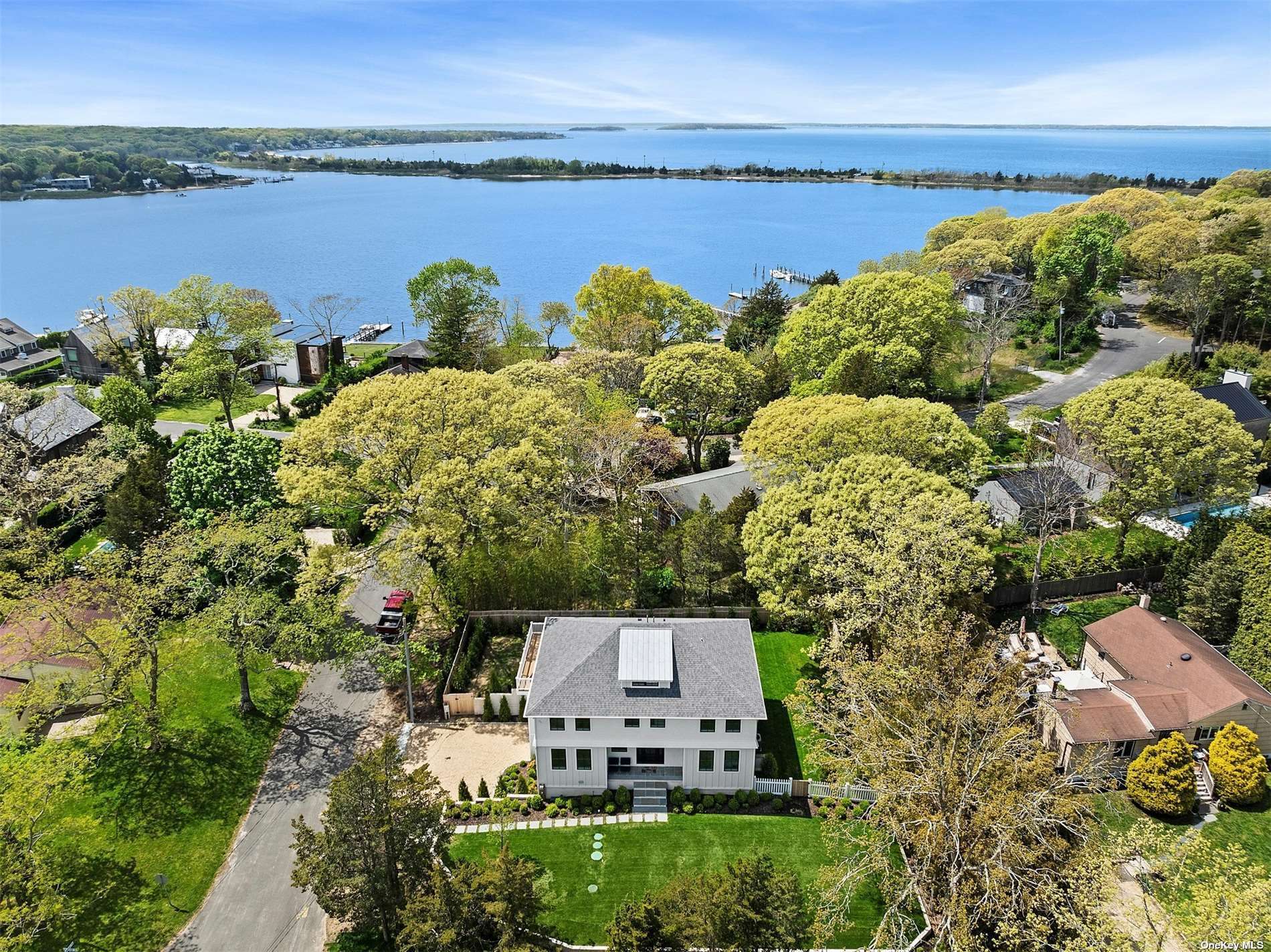 a view of a lake with couches in front of house