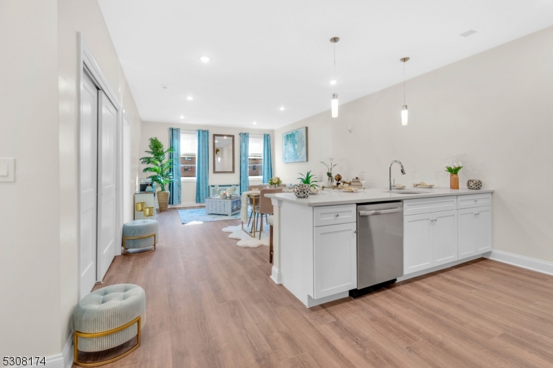 a kitchen with a sink and wooden floor