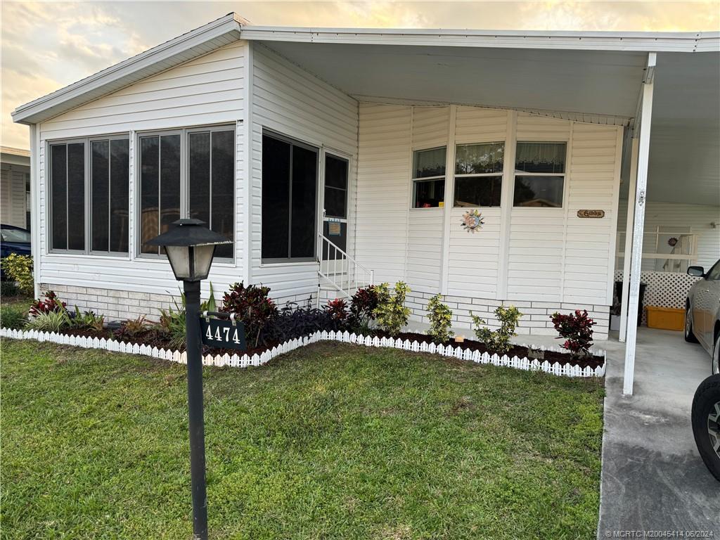 a front view of a house with a garden