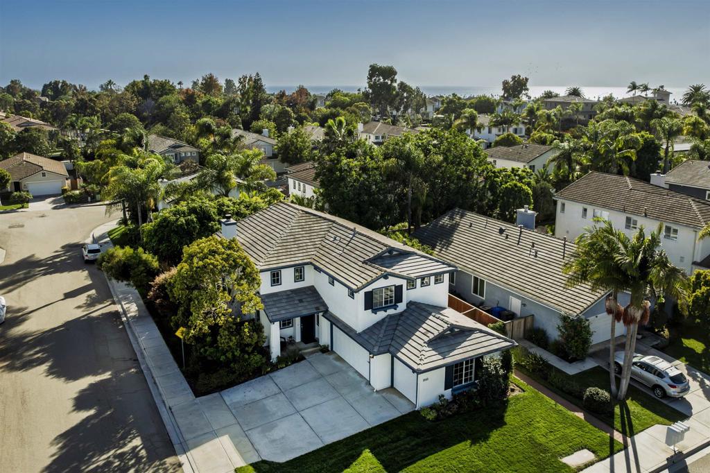 an aerial view of a house with garden space and street view