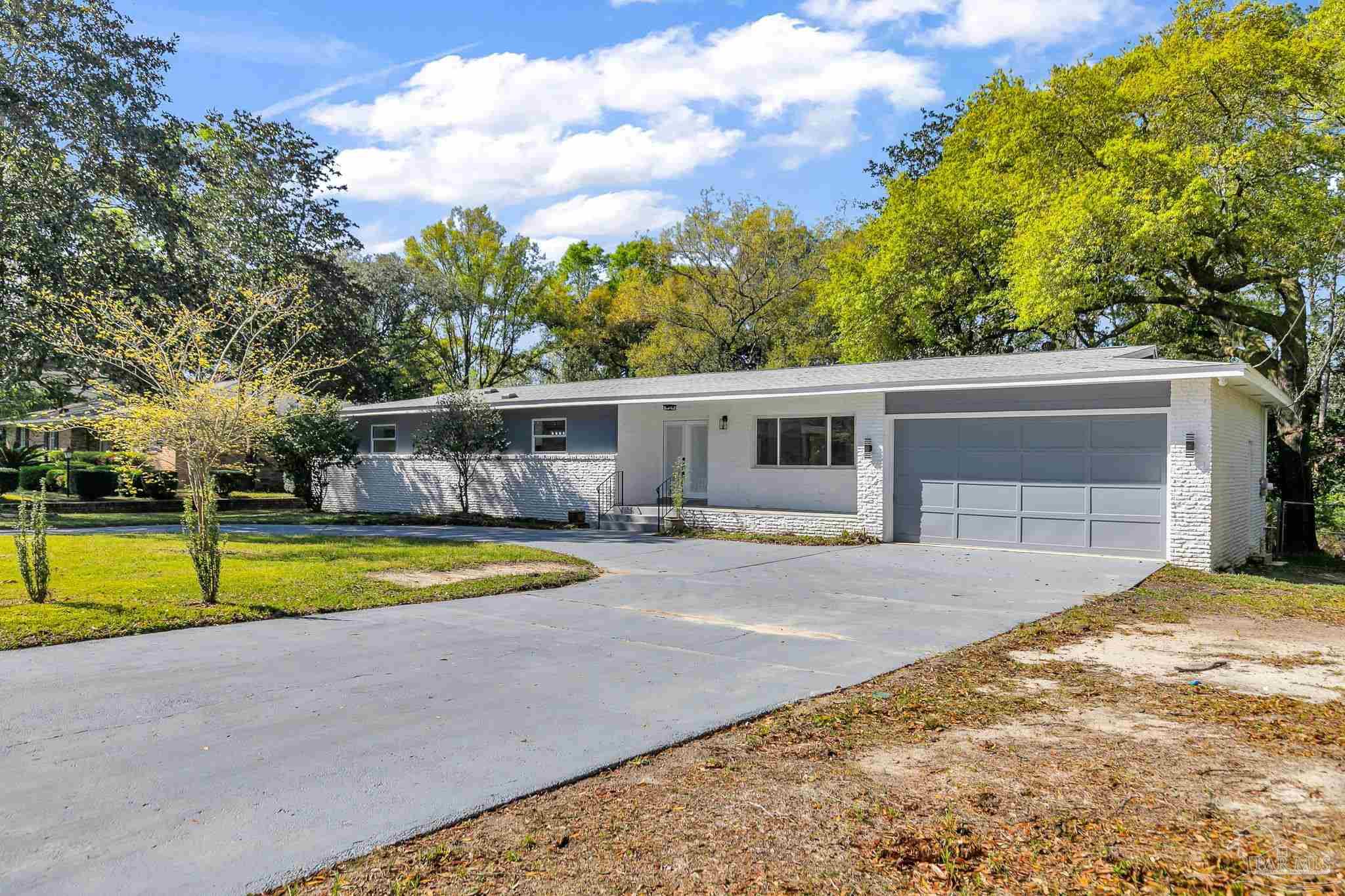 a view of a house with pool and a yard