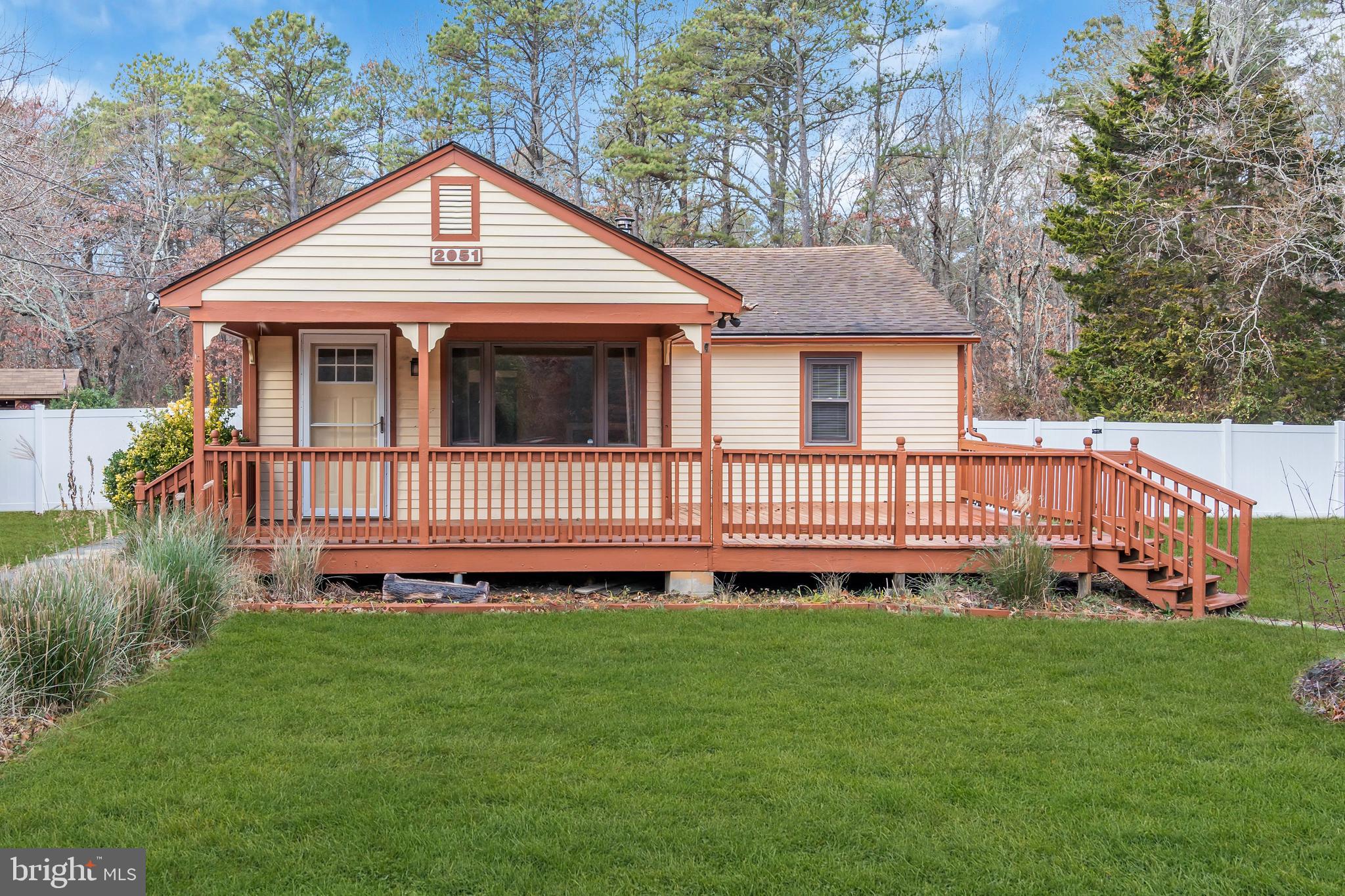 a front view of a house with a garden and deck