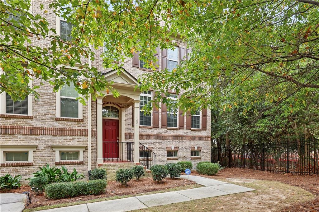 front view of a brick house with a small yard