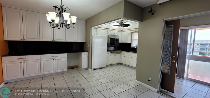 a view of a kitchen with a sink and cabinets