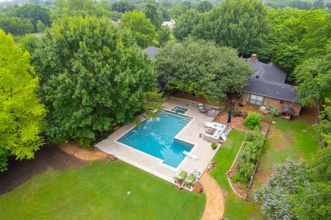 an aerial view of a house with a yard