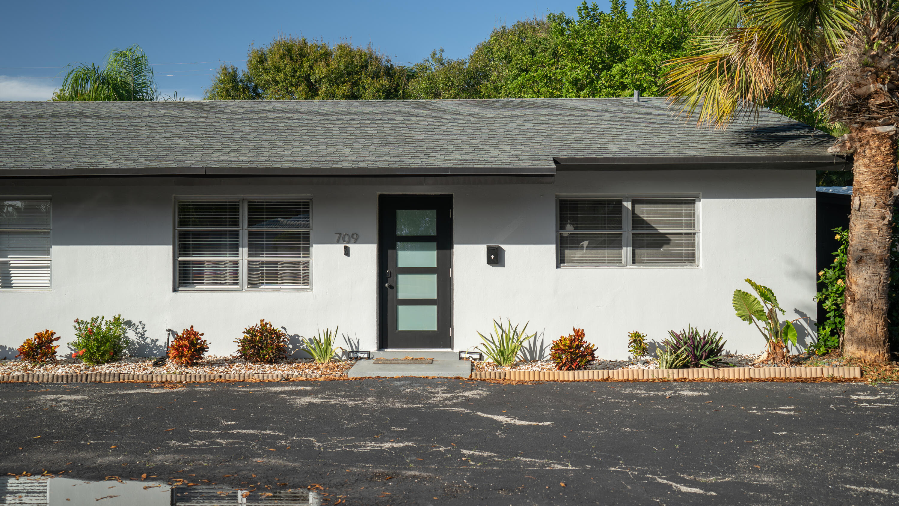 a front view of a house with a yard and a garage