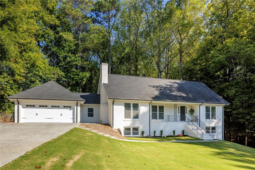 a front view of a house with a yard and outdoor seating