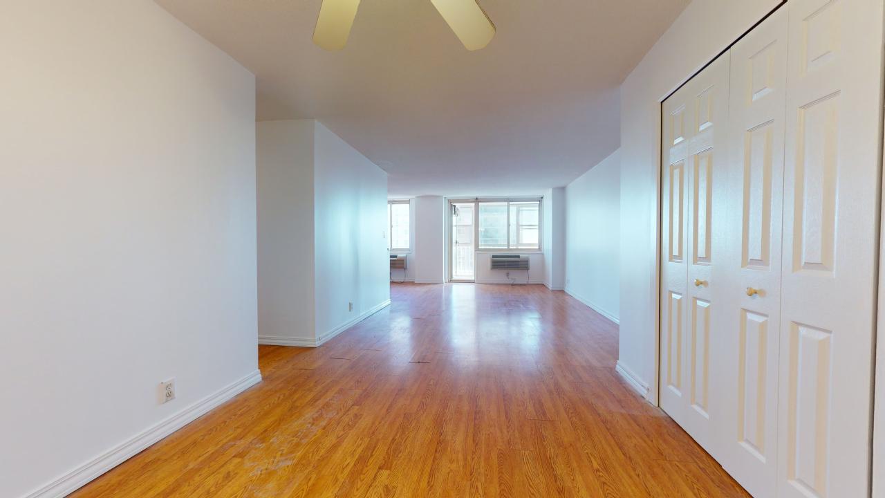 Hallway with light hardwood / wood-style flooring