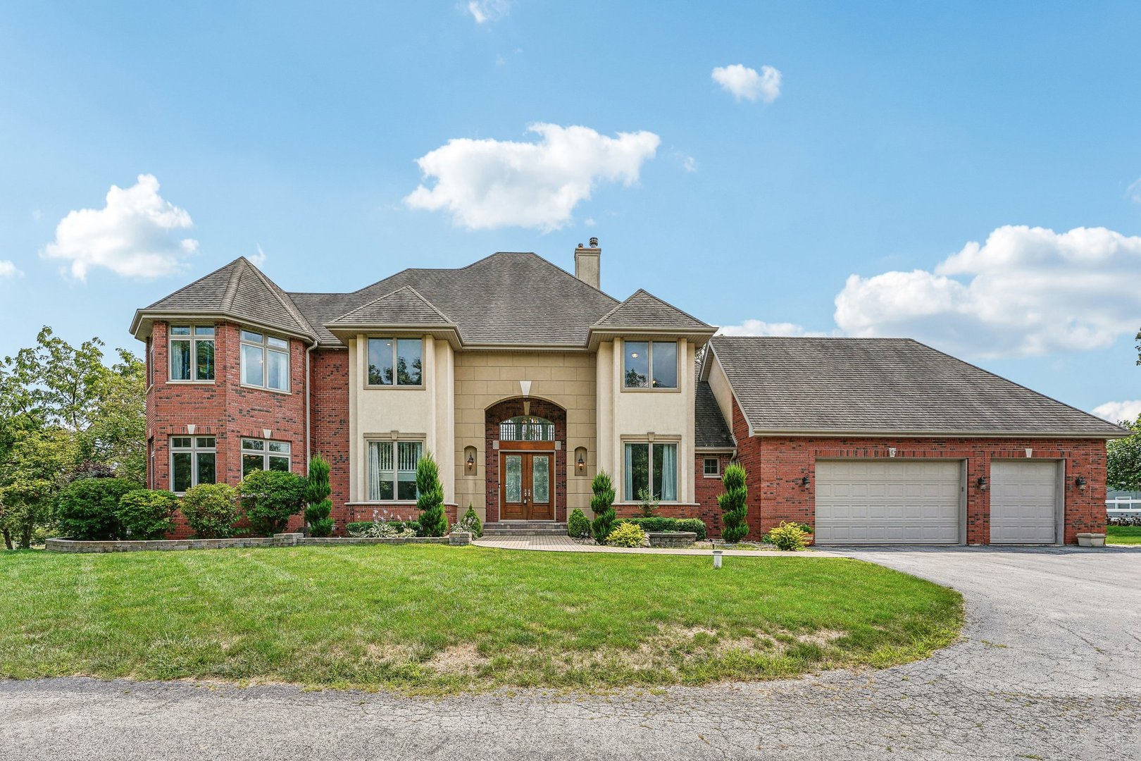 a front view of a house with a garden