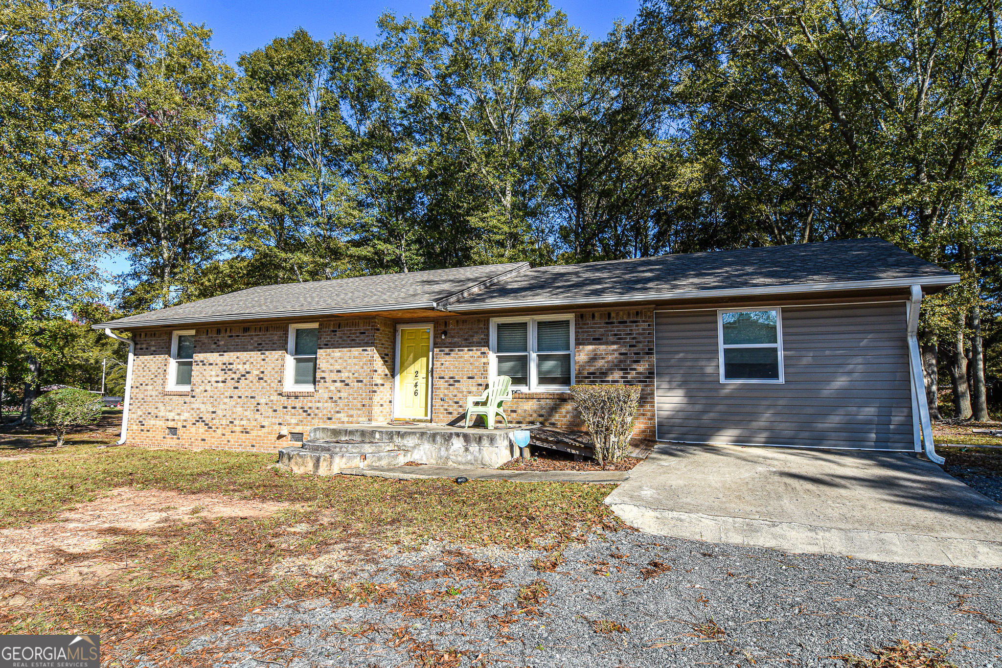 a front view of house with yard outdoor seating and barbeque oven