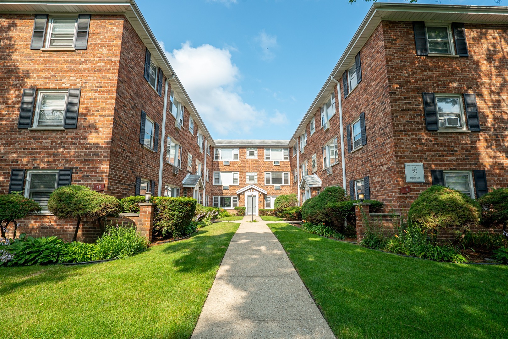 a view of a brick building next to a yard