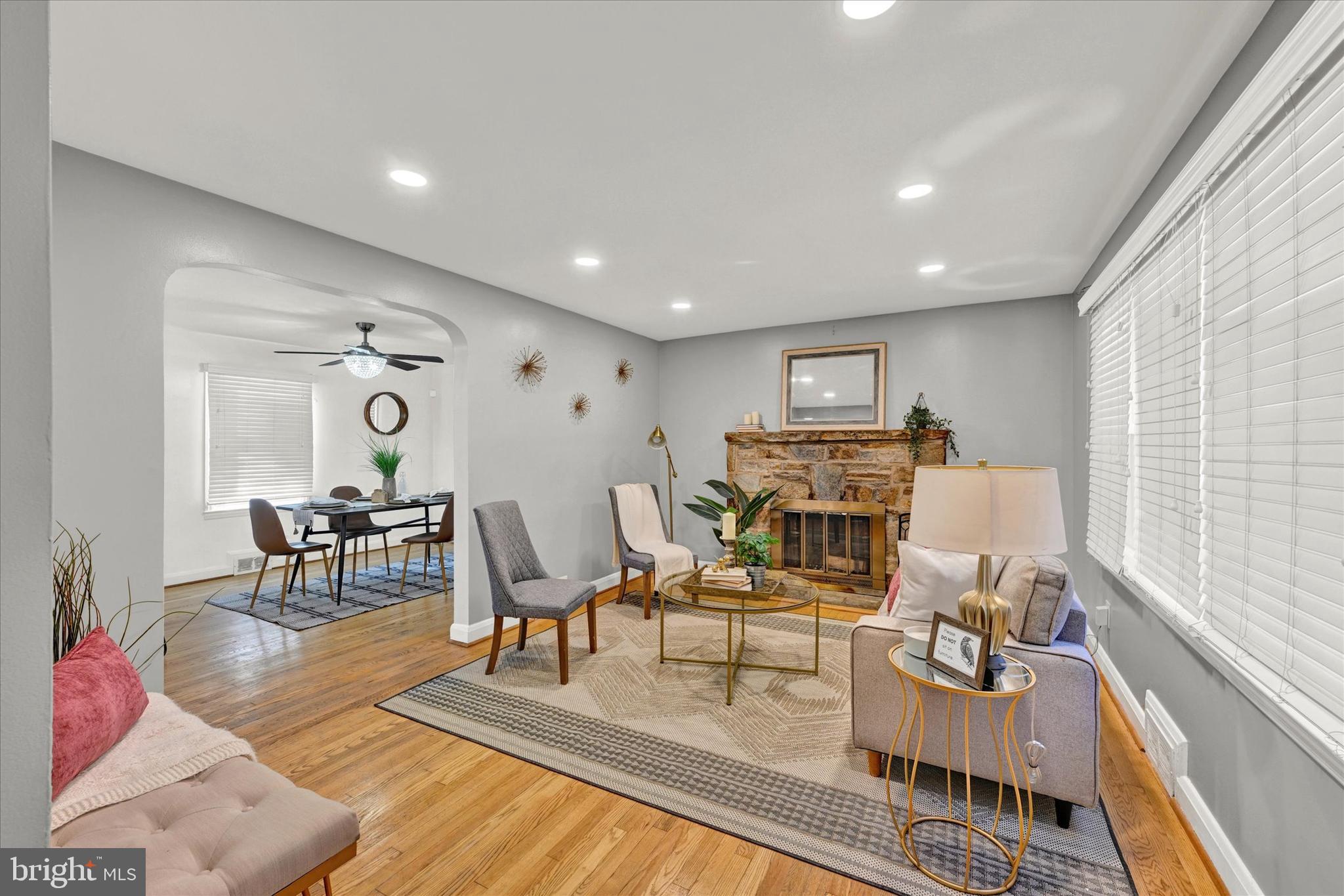 a living room with fireplace furniture and a wooden floor