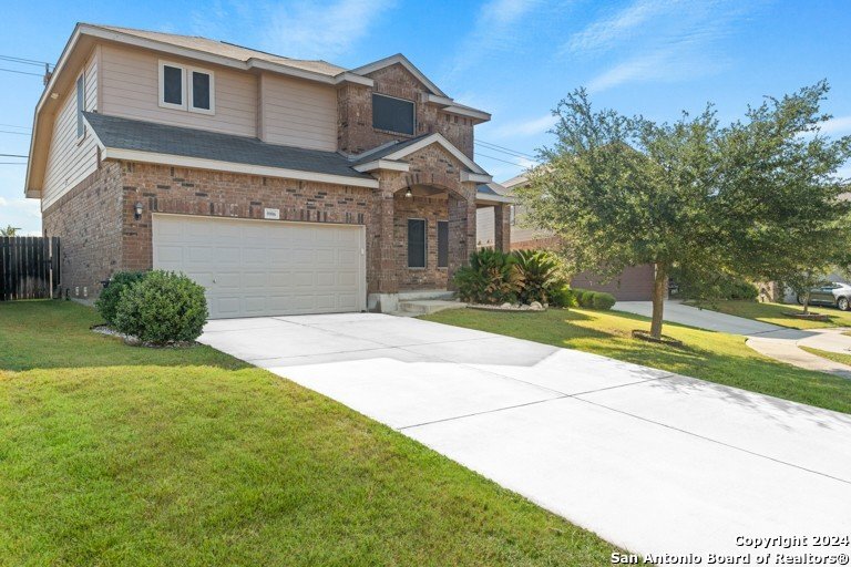 a front view of a house with a yard