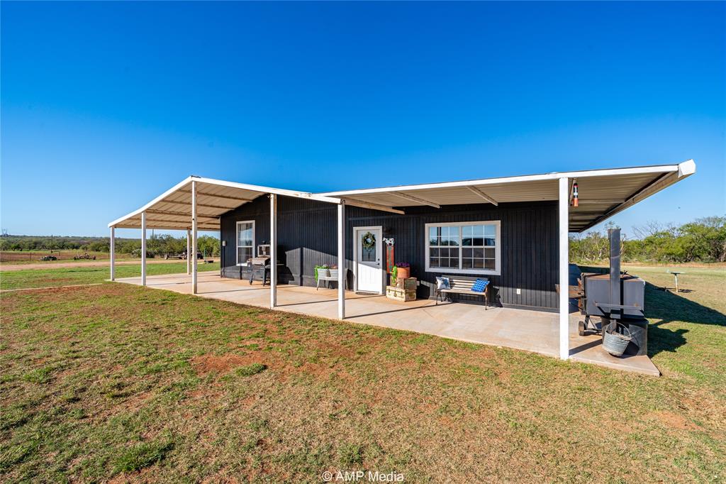 a view of a house with backyard porch and sitting area