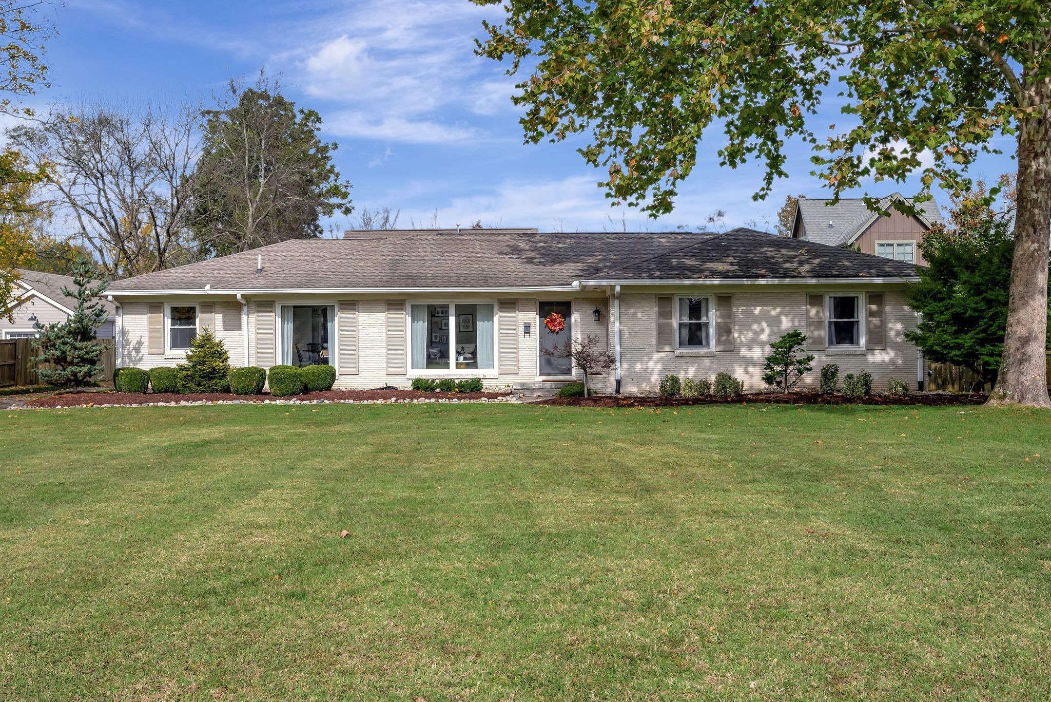 a front view of a house with a garden