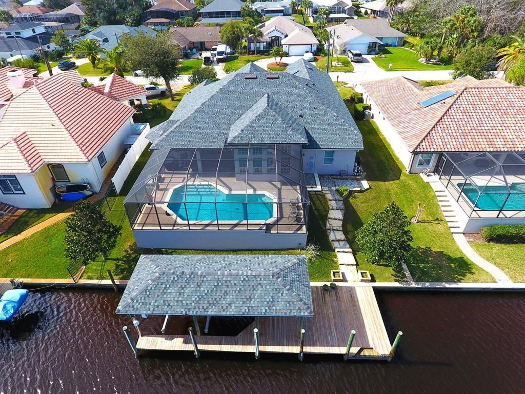 an aerial view of a house with a yard basket ball court and outdoor seating